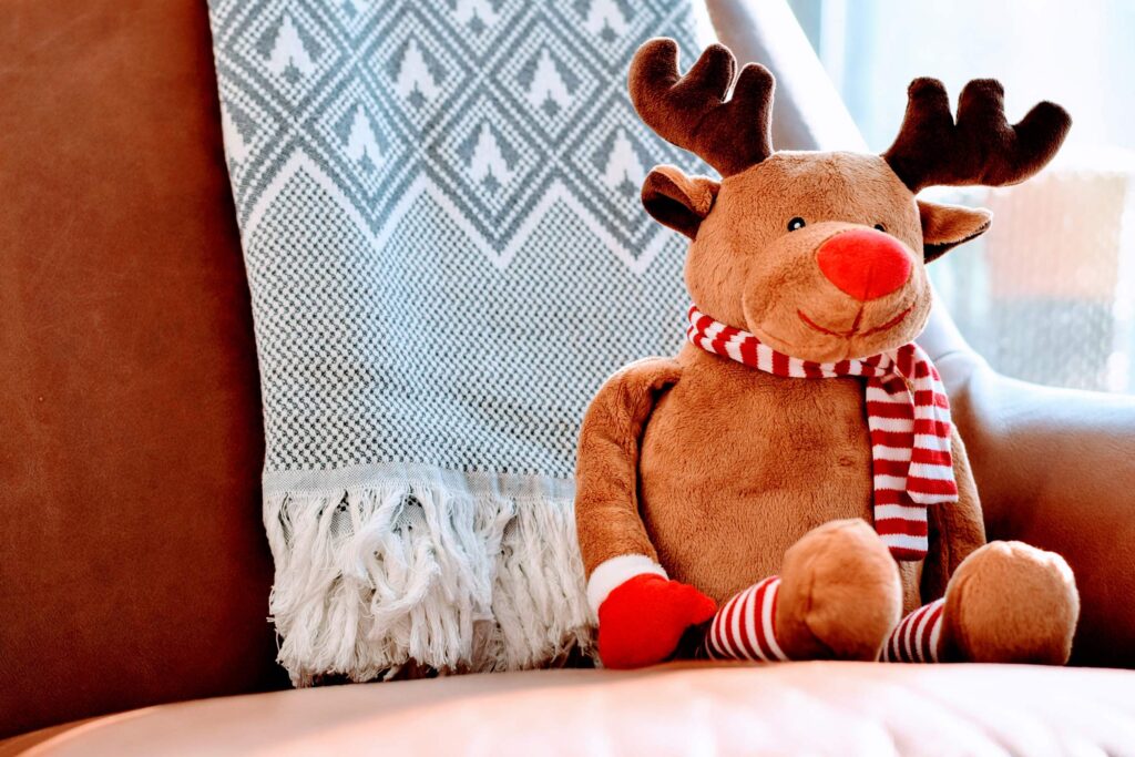 stuffed reindeer sitting on couch for Pre-Holiday Carpet Cleaning
