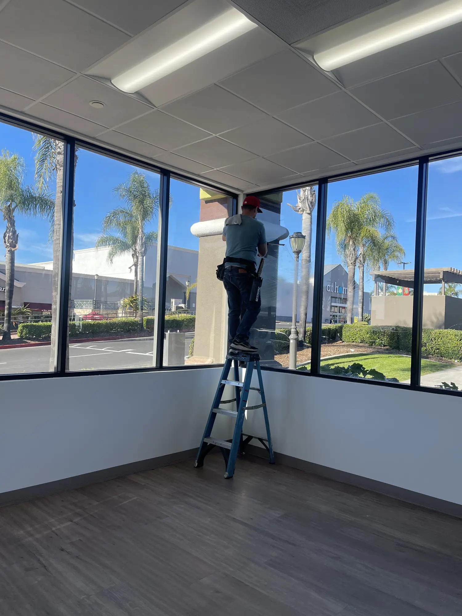 Commercial janitorial staff performing precision window and building maintenance for a San Diego facility